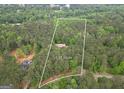 Aerial view highlighting 5.54 acres of wooded land with a charming home at 428 Turner Rd, Mcdonough, GA 30252