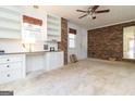 Spacious bedroom with built-in desk, shelving and brick accent wall at 2118 Allaire Ne Ln, Atlanta, GA 30345