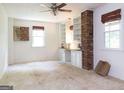 Bedroom featuring neutral carpet, built-in shelving, and brick pillar at 2118 Allaire Ne Ln, Atlanta, GA 30345