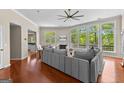Bright living room with hardwood floors, fireplace, and many windows with beautiful wooded scenery at 679 Bo Bo Banks Rd, Grantville, GA 30220
