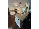 Bright kitchen with granite counters, stainless appliances, and large island with seating at 223 Rivers Rd, Fayetteville, GA 30214