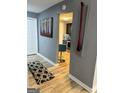 Hallway featuring modern decor leading to a kitchen with stainless steel appliances at 5894 Par Three Ct, Lithonia, GA 30038