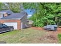 Backyard view with seating, vehicle, and partial view of the house at 4250 Edgewater Nw Ct, Kennesaw, GA 30144