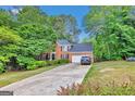 Brick home with a long driveway and mature landscaping providing shade and curb appeal at 4250 Edgewater Nw Ct, Kennesaw, GA 30144