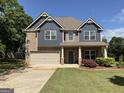 Beautiful two-story home with brick and siding, manicured lawn, and attached two-car garage at 101 Elkins Blvd, Locust Grove, GA 30248
