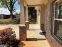 Covered front porch with brick pillars leading to the home's entrance at 101 Elkins Blvd, Locust Grove, GA 30248