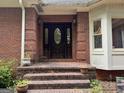 Charming brick entrance with a classic wood door and decorative glass accents, adding curb appeal to the home at 115 Stable Creek Rd, Fayetteville, GA 30215