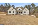Charming single-Gathering home featuring painted brick, a manicured lawn, and a walkway to the front entrance at 135 Wet Wood Dr # 12, Fairburn, GA 30213