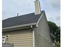 Home exterior showcasing new roof, vinyl siding, gutters, and chimney on a sunny day at 1871 Sandy Trail Dr, Hampton, GA 30228