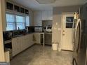 Well-lit kitchen featuring granite countertops, white cabinets, and stainless steel appliances at 1254 Ne Woodland Rd, Conyers, GA 30012