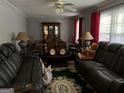 Cozy living room with plush seating, a decorative rug, and ample natural light at 1254 Ne Woodland Rd, Conyers, GA 30012