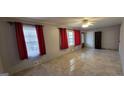 Bright living area with large windows, tile flooring, and neutral-toned walls at 1254 Ne Woodland Rd, Conyers, GA 30012