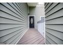 A welcoming front door is adorned with a glass pane, set between light green siding at 325 Berry Ct, Villa Rica, GA 30180