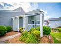 A charming front porch with a garden is framed by green bushes at 325 Berry Ct, Villa Rica, GA 30180