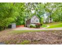 Two-story home featuring a two-car garage, shed, and ample parking on a sprawling lot at 10 Queens Ct, Sharpsburg, GA 30277