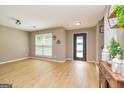 Bright, open living room featuring new floors, a window with blinds, and neutral paint at 10 Queens Ct, Sharpsburg, GA 30277
