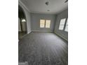 Bright and airy living room with plush carpeting, neutral paint, and natural light from several windows at 937 Sw Metropolitan Sw, Atlanta, GA 30310