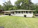 White brick home with black shutters and a well-manicured lawn provides a welcoming exterior at 2165 Pemberton Rd, Atlanta, GA 30331