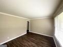 Bright living room with hardwood floors, crown molding and a large window at 2165 Pemberton Rd, Atlanta, GA 30331