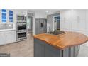 Spacious kitchen with stainless appliances, custom cabinets, and an island with a wood countertop at 230 Shorewood Ct, Mcdonough, GA 30252