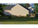 Spacious backyard with lush green lawn and a quaint wooden deck at 1525 Racquet Club Dr, Lawrenceville, GA 30043