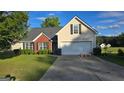 Charming home featuring well-kept lawn, a two-car garage, and classic siding at 1525 Racquet Club Dr, Lawrenceville, GA 30043