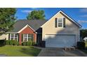 Traditional home boasting a manicured lawn, and an attached two-car garage at 1525 Racquet Club Dr, Lawrenceville, GA 30043