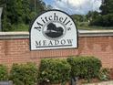 Mitchell's Meadow community sign at the entrance, showcasing landscaping at 4551 Mitchells Meadow Ln, Ellenwood, GA 30294