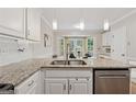 Close up shot of kitchen features granite countertops, stainless steel appliances, and a stainless steel sink at 2622 Murdock, Marietta, GA 30062