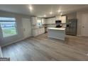 Bright kitchen with stainless steel appliances, island, and granite countertops at 11045 Shadow Creek Ter # 65, Hampton, GA 30228