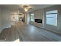 Spacious living room with fireplace, ceiling fan and luxury vinyl plank flooring at 11045 Shadow Creek Ter # 65, Hampton, GA 30228