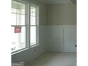 Bright, spacious living area features large windows and pristine white trim accents at 49 Durham Estates Dr, Sharpsburg, GA 30277
