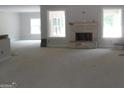 Cozy living room with stone fireplace and large windows for natural light at 49 Durham Estates Dr, Sharpsburg, GA 30277