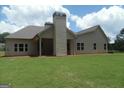 Expansive backyard featuring a covered porch area and well-maintained lawn at 49 Durham Estates Dr, Sharpsburg, GA 30277