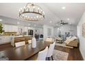 Open-concept living space with island seating, modern lighting, and hardwood floors at 2541 Peyton Woods Sw Trl, Atlanta, GA 30311