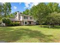 Inviting two-story home with a well-maintained lawn, set amidst lush trees for added privacy at 101 Jasmine Path, Peachtree City, GA 30269