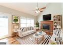 Bright and inviting living room with a vaulted ceiling, fireplace, and stylish decor at 1416 Emerald Pine Ct, Lawrenceville, GA 30043