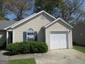 Charming single-story home featuring light siding, manicured landscaping, and an attached one-car garage at 5799 Eagles Feather Ln, Riverdale, GA 30274