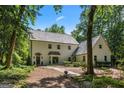 Beautiful home featuring mature landscaping and a stone walkway at 1260 Heards Ferry Rd, Sandy Springs, GA 30328