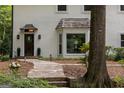 Inviting front entry with a natural wood door, elegant lighting, and a stone walkway at 1260 Heards Ferry Rd, Sandy Springs, GA 30328