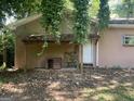 Exterior backyard view highlighting the partially covered entrance and dog house; natural surroundings at 191 Lagrange St, Grantville, GA 30220
