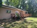 Charming home featuring a wrap-around deck, perfect for outdoor entertaining in a private backyard setting at 191 Lagrange St, Grantville, GA 30220