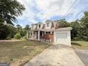 Charming brick home featuring dormer windows and an attached single car garage at 305 Anderson Cir, Covington, GA 30016
