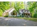 Beautiful two-story home with lush landscaping, mature trees, and a welcoming front porch at 465 Willowbrook Dr, Smyrna, GA 30082