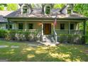 Charming home with manicured lawn, stone walkway, and covered front porch at 465 Willowbrook Dr, Smyrna, GA 30082