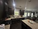 Eat-in kitchen with stainless steel appliances, dark wood cabinets and granite countertops, perfect for modern living at 7644 Wrotham Cir, South Fulton, GA 30349