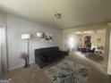 Living room with a modern sofa, decorative art, and an open layout at 7644 Wrotham Cir, South Fulton, GA 30349