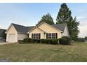 Charming one-story home with a well-manicured lawn and attached garage at 486 Village Cir, Stockbridge, GA 30281