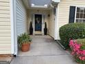 Inviting front entrance with potted plants and manicured shrubs at 486 Village Cir, Stockbridge, GA 30281