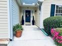 Inviting front entrance with potted plants and a stylish wreath on the door at 486 Village Cir, Stockbridge, GA 30281